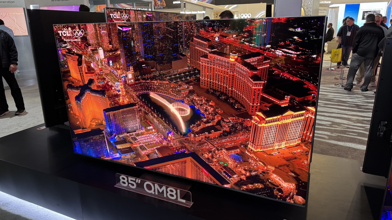 TCL C8L  QM8L on stand with cityscape on screen