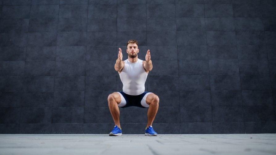 a man doing a sumo squat