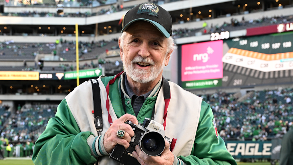 Philadelphia Eagles photographer Ed &#039;Eagles&#039; Eye&#039; Mahan holds a Nikon F at an Eagles game 