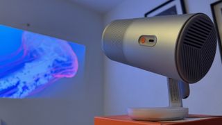 The Xgimi MoGo 4 portable projector close-up, with an image of a jellyfish in the background