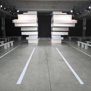 The set designer's studio created twin geometric structures that provided a narrow entrance for Edun's multi-cultural collection
