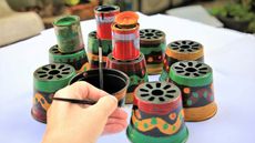 painting old plastic plant pots by hand