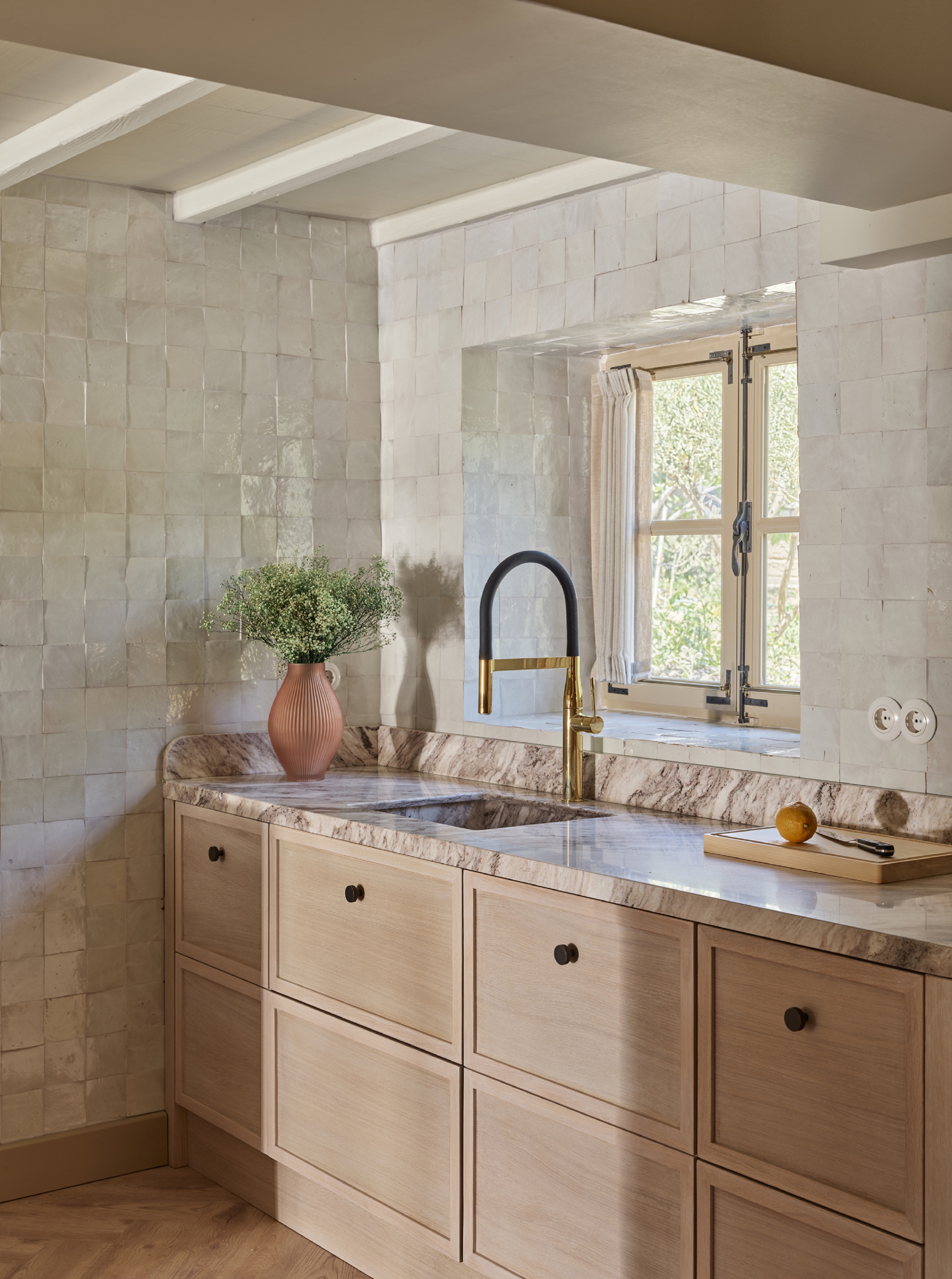 light neutral kitchen with white zellige tiles from floor to ceiling