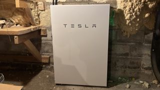 A Tesla powerwall battery in the basement of a house