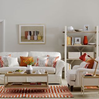 white living room with orange accents