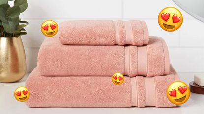 A pink Target bath towel with heart eye emojis around it