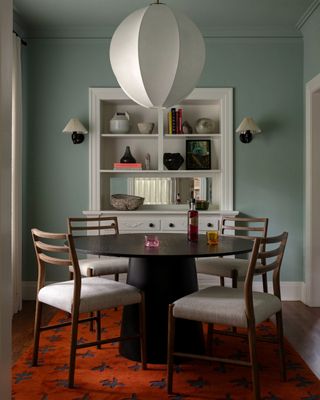 light blue dining room paint with red rug