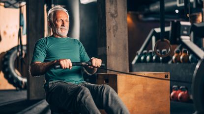 Older man on rowing machine for fitness