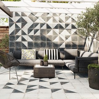 outdoor dining area with concrete-effect paving tiles