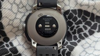 The rear of the Suunto Race laid on a pillow