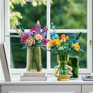 LEGO wildflowers set in clear vases on windowsill