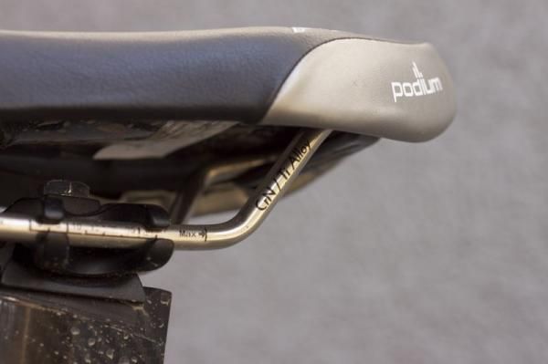 The podium features titanium rails and rear scuff guards.