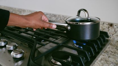 Woman cooking on a gas hob