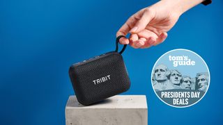Tribit PocketGo Bluetooth Speaker photographed in front of a blue background with a Presidents' Day deals badge