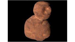 up-close spacecraft photo of a brownish-red two-lobed deep-space object that looks a lot like a snowman