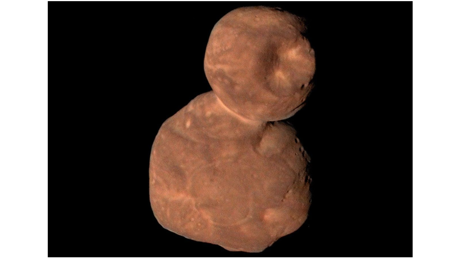 up-close spacecraft photo of a brownish-red two-lobed deep-space object that looks a lot like a snowman