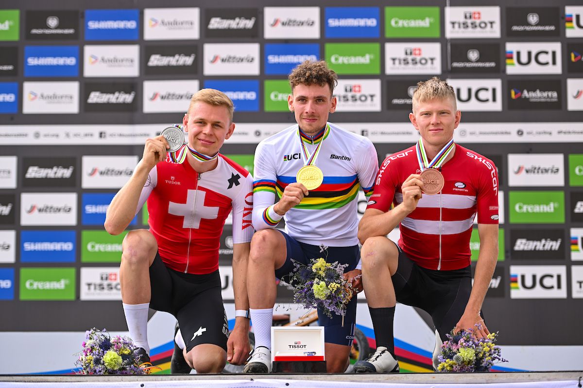 Picture by Will Palmer/SWpix.com - 01/09/2024 - Cycling - 2024 UCI Mountain Bike World Championships - Pal Arinsal, Arinsal, Andorra - Men Under 23 Cross-country Olympic Final Podium - Luca Martin (France) receiving the Gold Medal with Dario Lillo (Switzerland) receiving the Silver Medal and Tobias Lillelund (Denmark) receiving the Bronze Medal