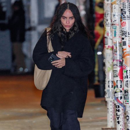 Zo&euml; Kravitz's Outfit to Taylor Swift's Birthday Party included blue jeans, a navy jacket, red socks, and loafers