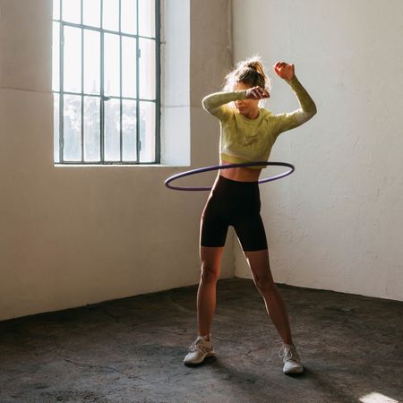 woman exercising with hula hoop