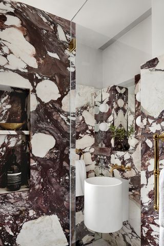 marble bathroom with modern white toilet and sink