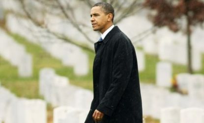 Obama walks among graves of soldiers from the Iraq and Afghan conflicts. 