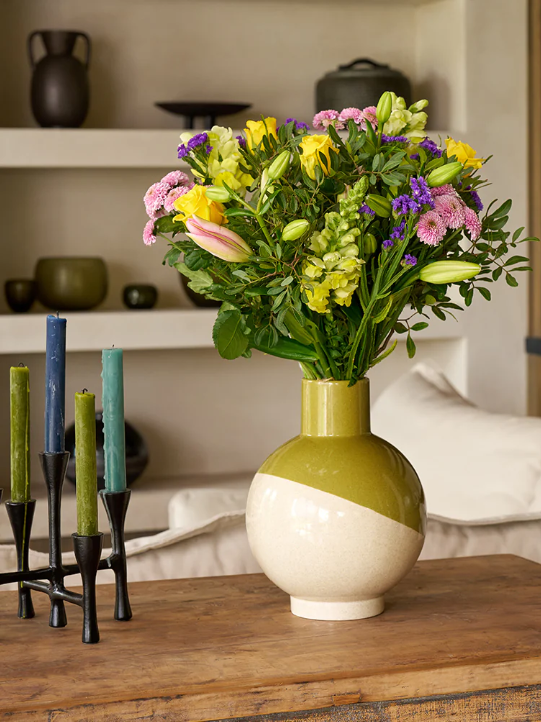 A dual-colored vase with a bouquet of flowers