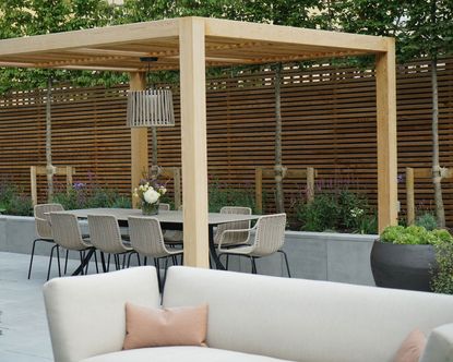 pergola idea for creating a dining area in a modern garden design by Farlam & Chandler