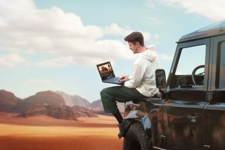 Man using ASUS ProArt P16 laptop in a desert environment