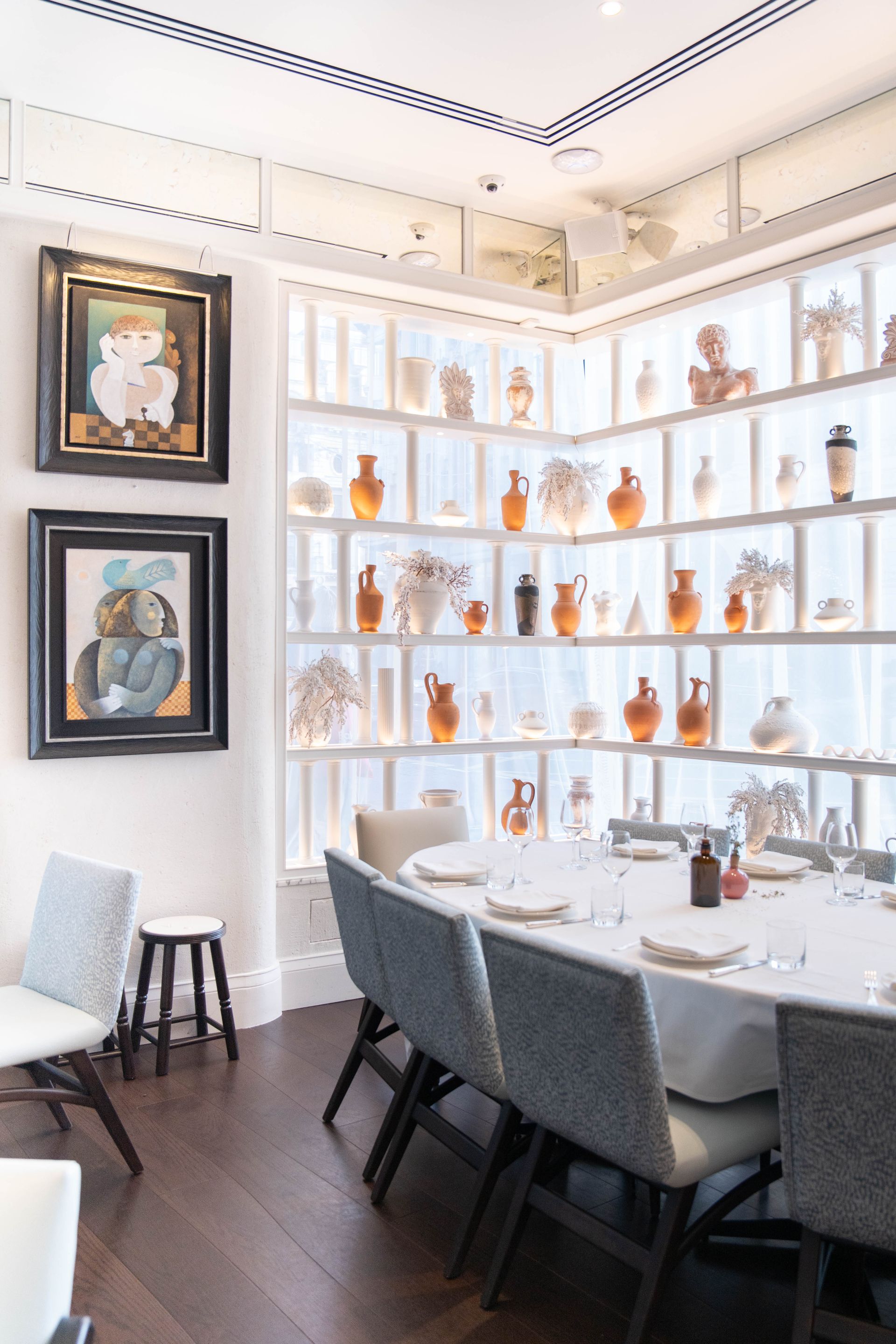 gaia restaurant interior, with objects lining shelves in window and art on wall