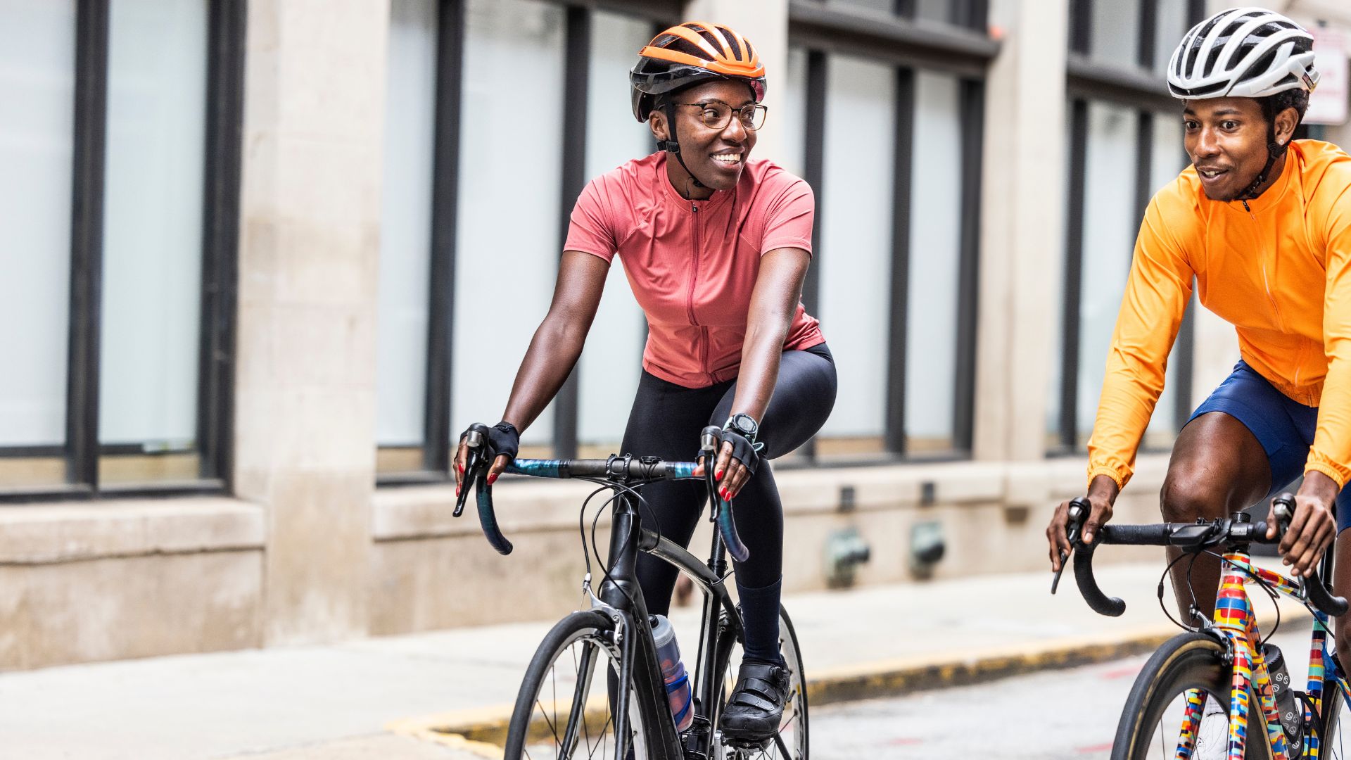 Woman riding bike with friend through city
