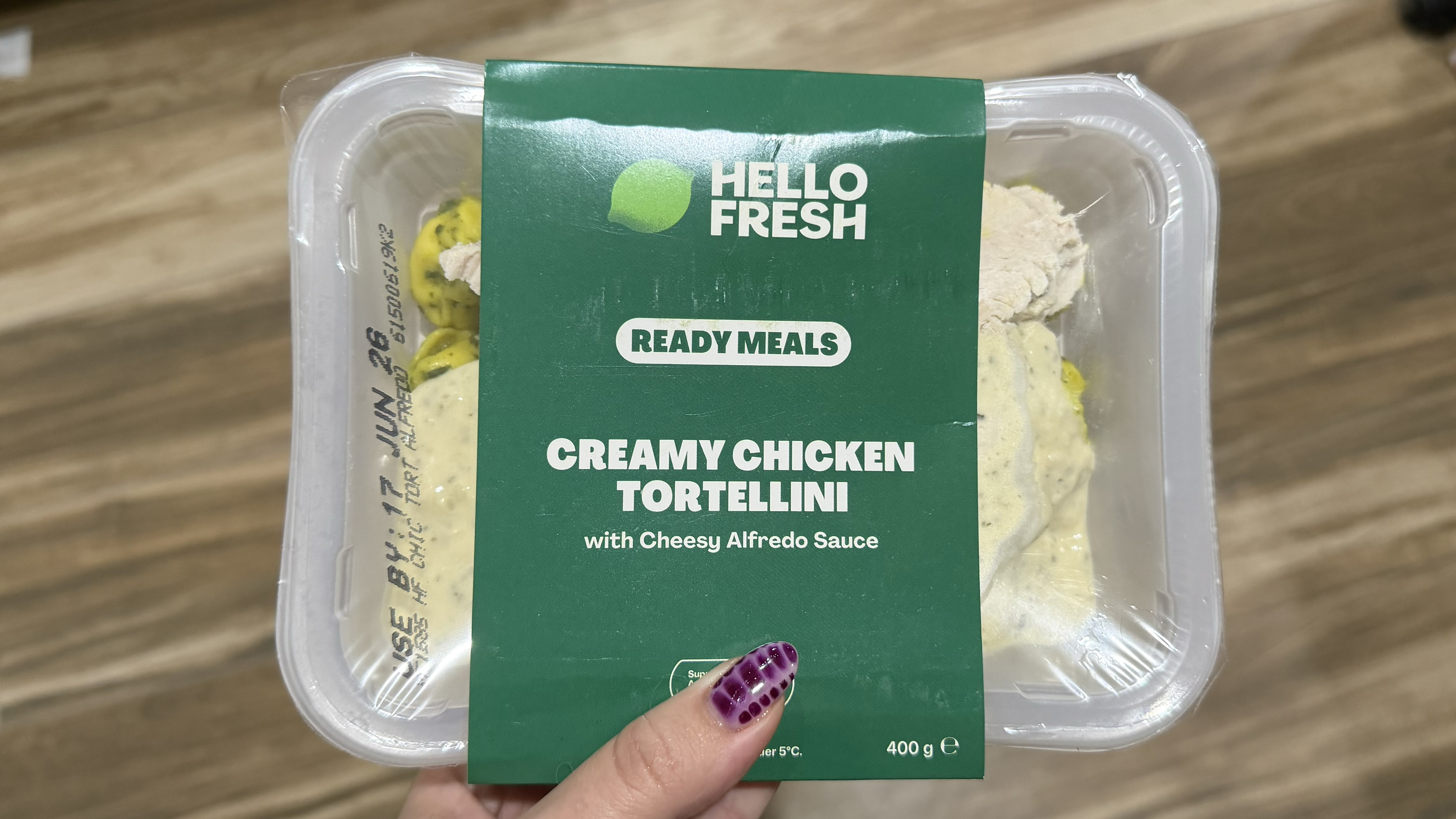 Hand holding Hellofresh meal