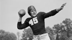 Vintage photo of football player throwing a football.