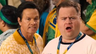 Elijah and Brad react in shock to the sausage mascot. 