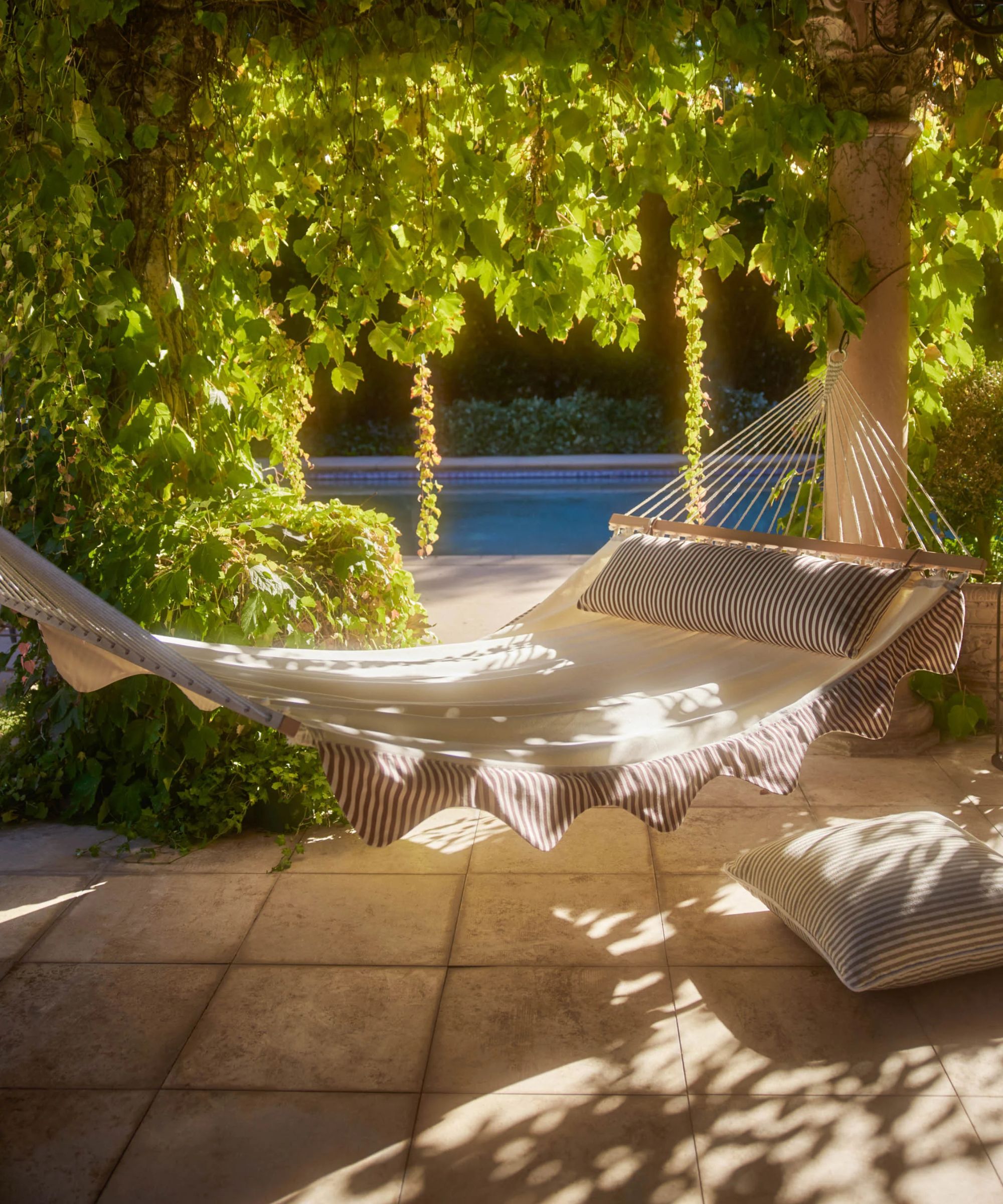 Lulu and Georgia hammock with striped scallop edges and a matching pillow