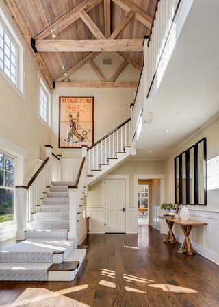 the high ceilings and exposed beams flood this hallway with natural light