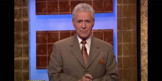 Alex Trebek in a suit introducing Jeopardy.