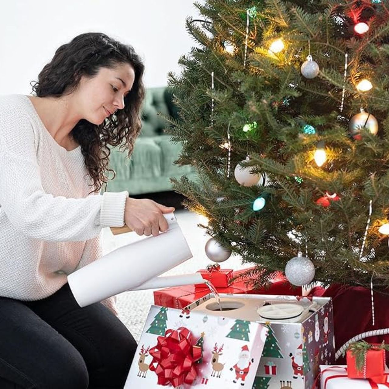 HoHoHoH2o Christmas tree watering system in use under decorated tree