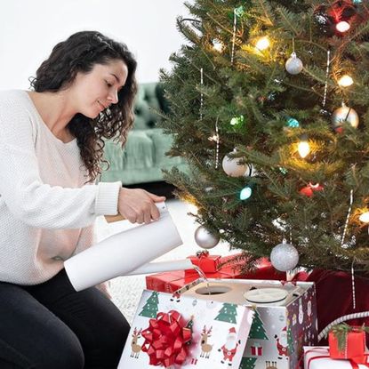 HoHoHoH2o Christmas tree watering system in use under decorated tree