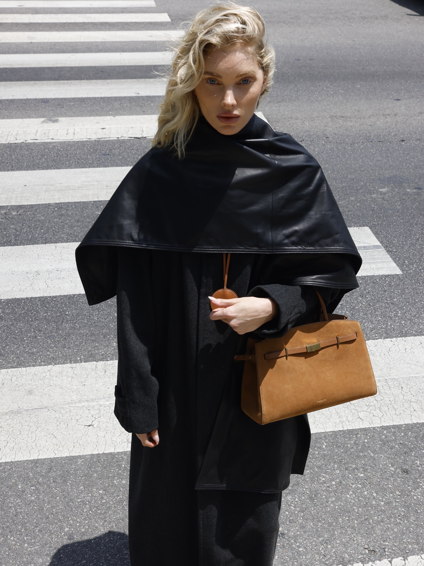 Meghan Markle wearing scarf neckline trend top in white.