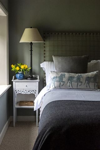 bedroom with bedside lamp and bed with pillows