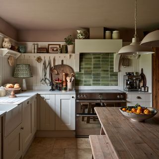 Green kitchen splashback with white cabinets and earthy brown ceiling