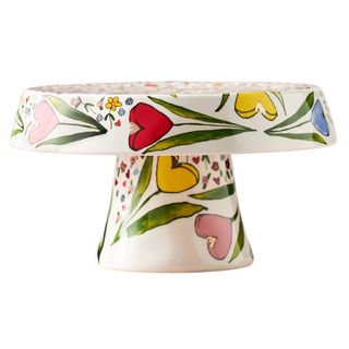 A ceramic cake stand decorated with colourful tulips