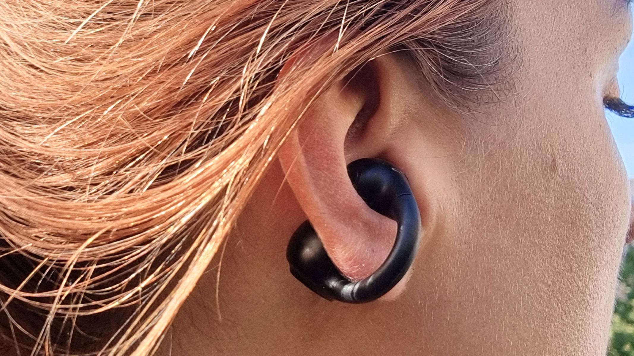A close-up picture of our reviewer wearing the JLab Flex Earbuds