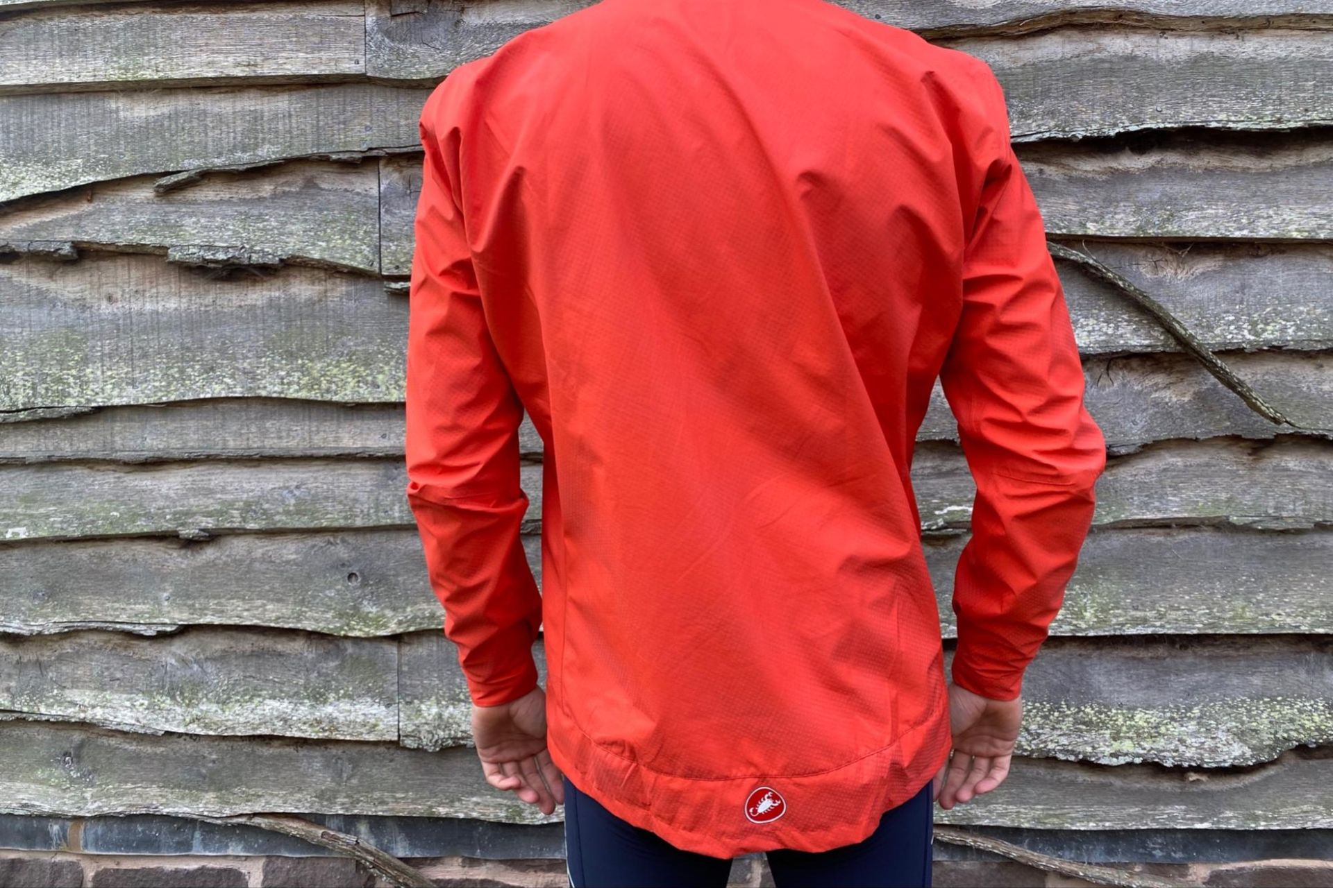 Image shows a rider wearing the Castelli Reflex Commuter Jacket.