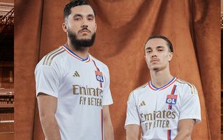 Rayan Cherki and Maxence Caqueret model the Lyon 2023/24 home shirt