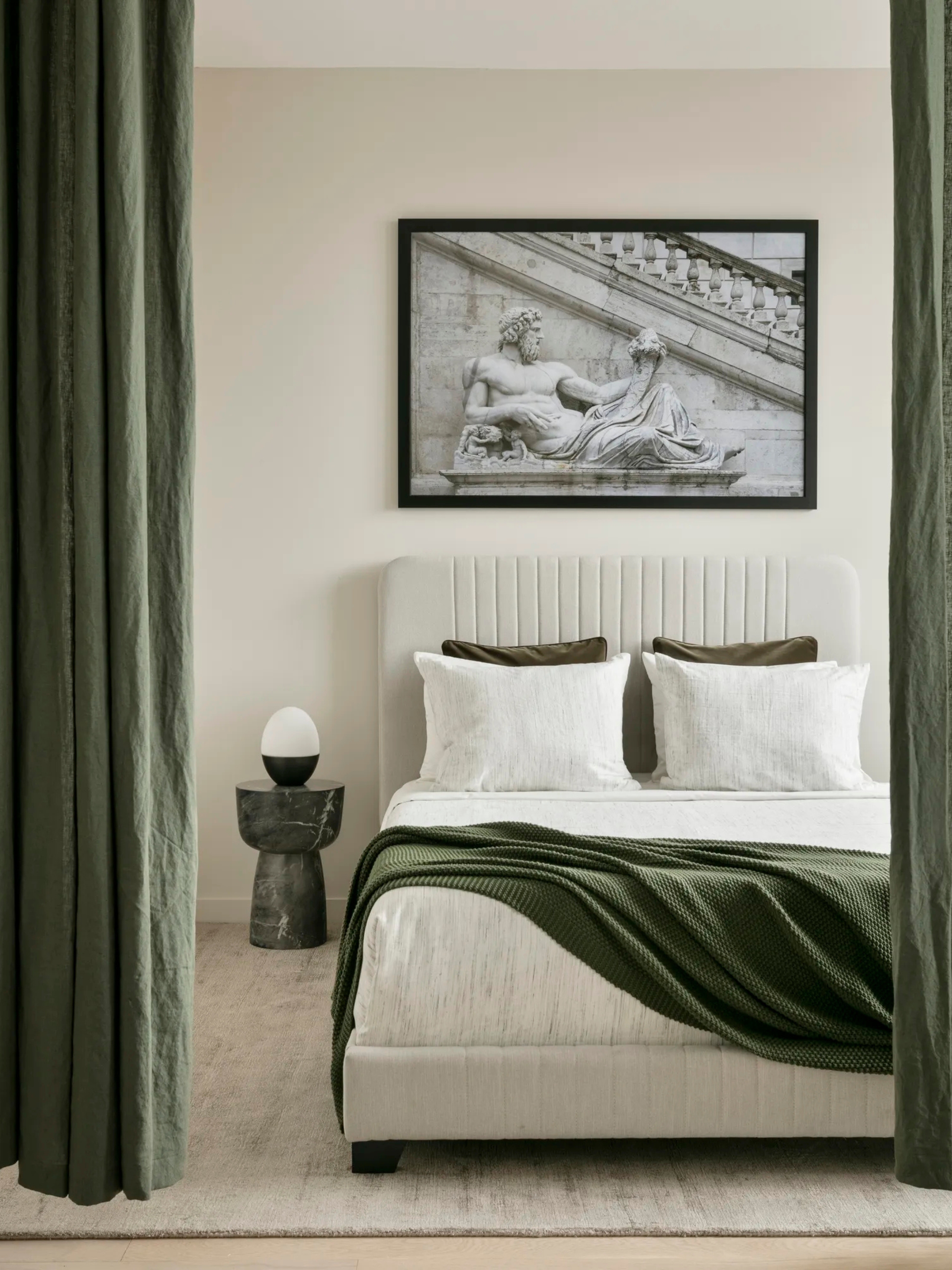 a white bedroom with a dark green accent color