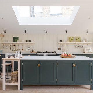 Blue country style kitchen with island and Kate Feather bench