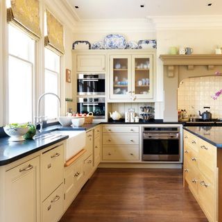 white kitchen with wooden flooring and drawers