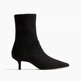 A side view of a kitten heel sock boot from H&M against a white background