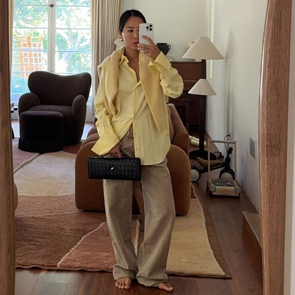 @aimeesong casual outfit selfie in yellow shirt and sweater